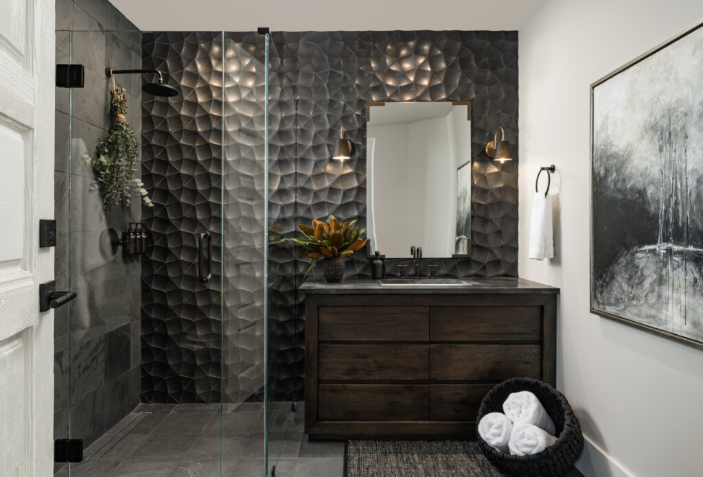 Luxury home bathroom in santa ynez santa barbara county 3d tile ogassian tile black tile rustic vanity with vintage mirror and vintage sconces abstract art