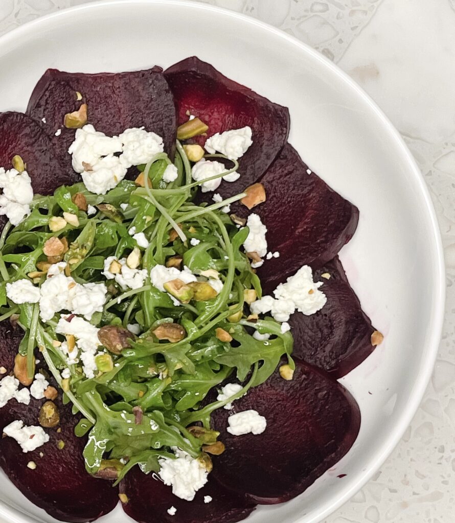 Arugula and beet salad with goat cheese and pistachios and honey vinaigrette dressing